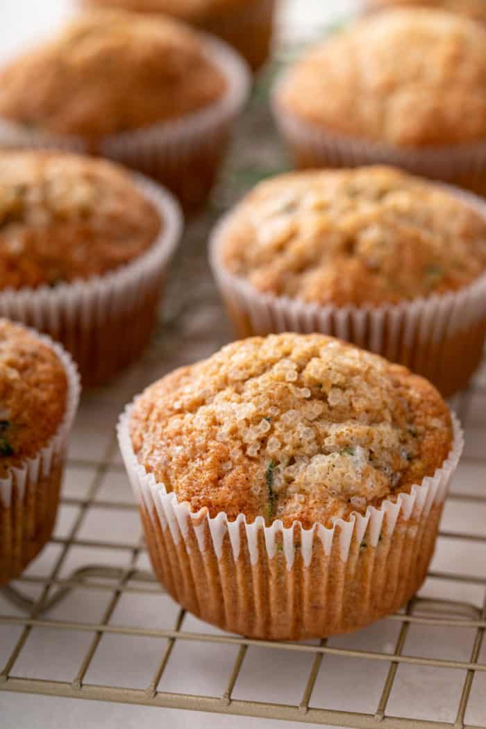 Close up image of zucchini muffins cooling on a wire rack.