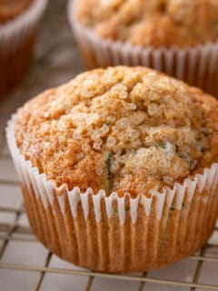 Close up of zucchini muffin cooling on a wire rack.