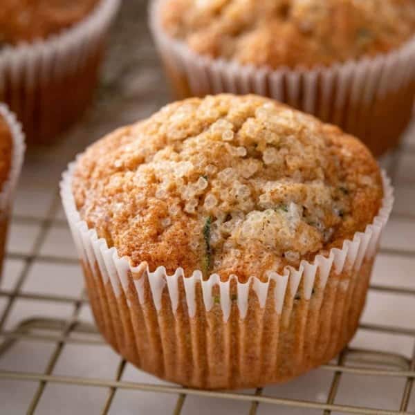 Close up of zucchini muffin cooling on a wire rack.