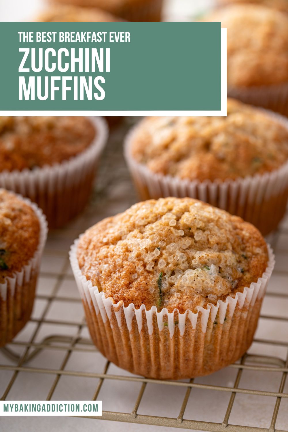 Close up image of zucchini muffins cooling on a wire rack. Text overlay includes recipe name.