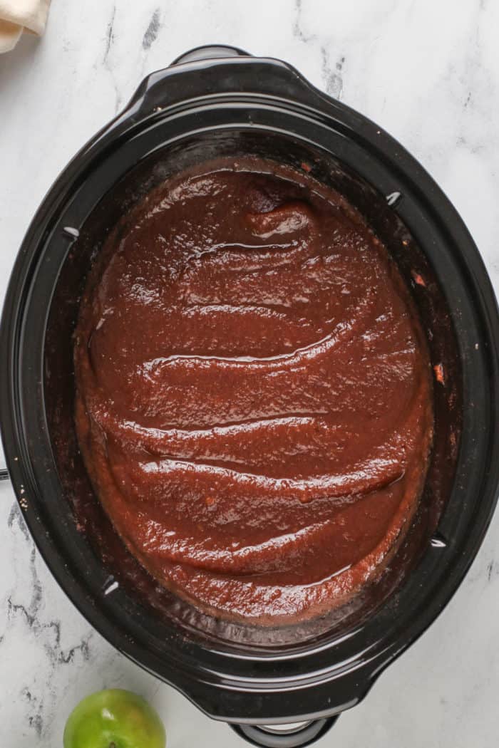 Freshly made apple butter in a slow cooker.