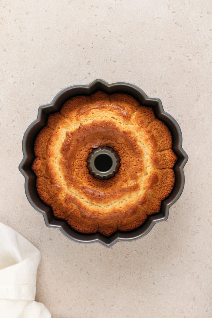 Baked vanilla bundt cake cooling in the cake pan.