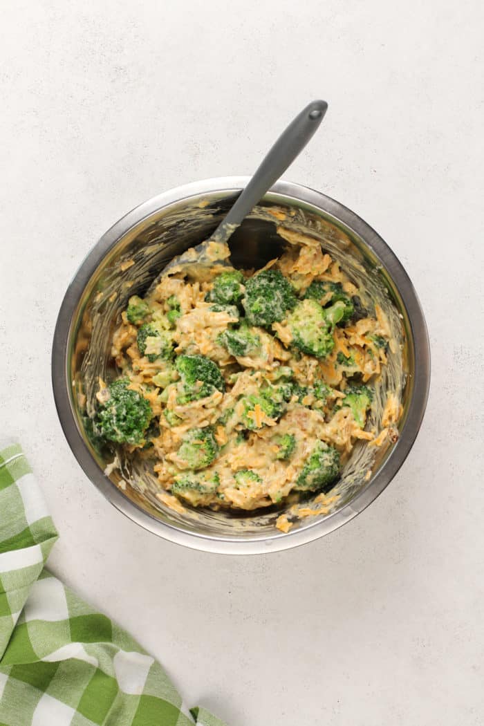 Broccoli casserole mixed up in a metal bowl.