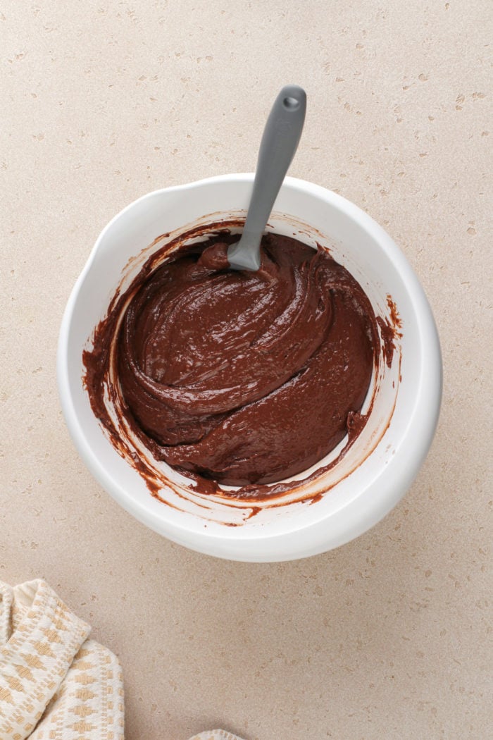 Chocolate cake batter in a white mixing bowl.