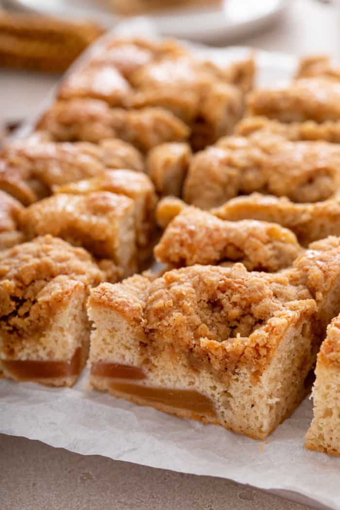 Close up of slices of easy apple coffee cake on a piece of parchment paper.
