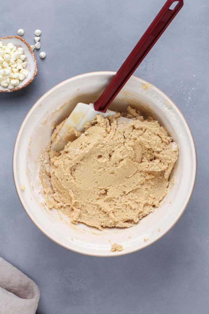 Dough base for white chocolate macadamia nut cookies in a bowl, ready for white chocolate chips and macadamia nuts to be added.