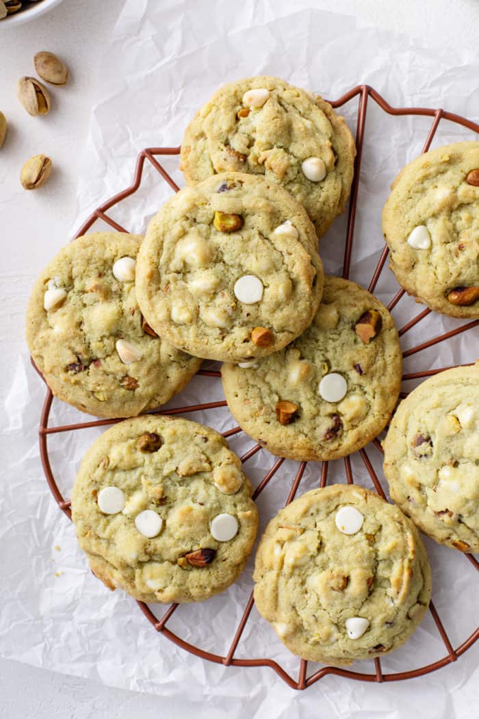White chocolate pistachio pudding cookies cooling on a wire rack.