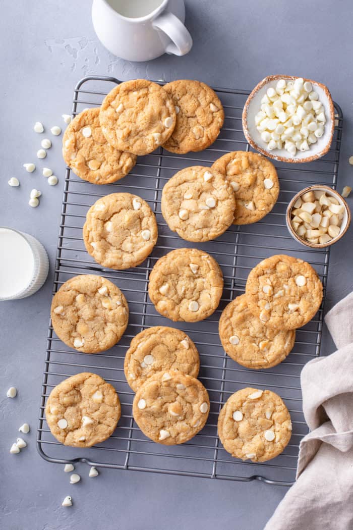 Overhead view of white chocolate macadamia nut cookies cooling on a wire rack.