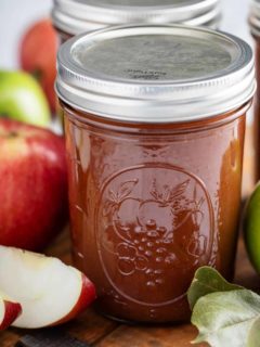 Close up of a jar of canned apple butter.