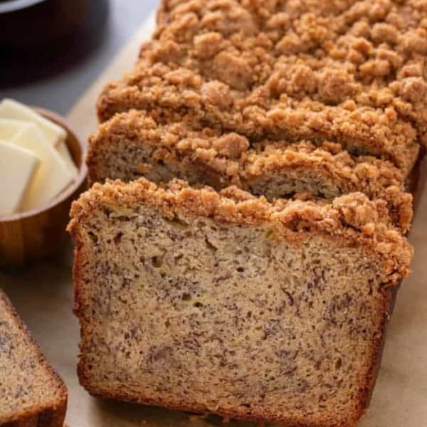 Loaf of brown butter banana bread cut into slices.