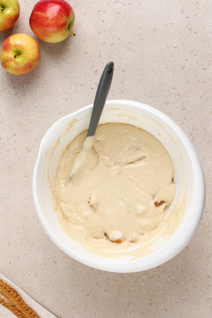 Batter for easy apple coffee cake in a white mixing bowl.