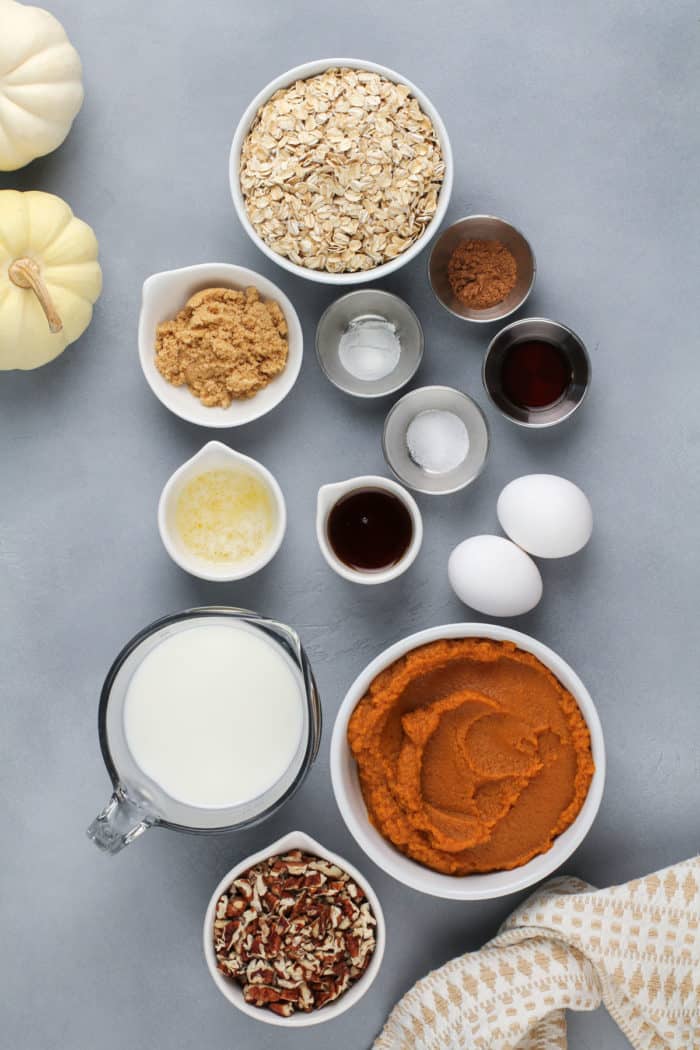 Pumpkin baked oatmeal ingredients arranged on a gray countertop.