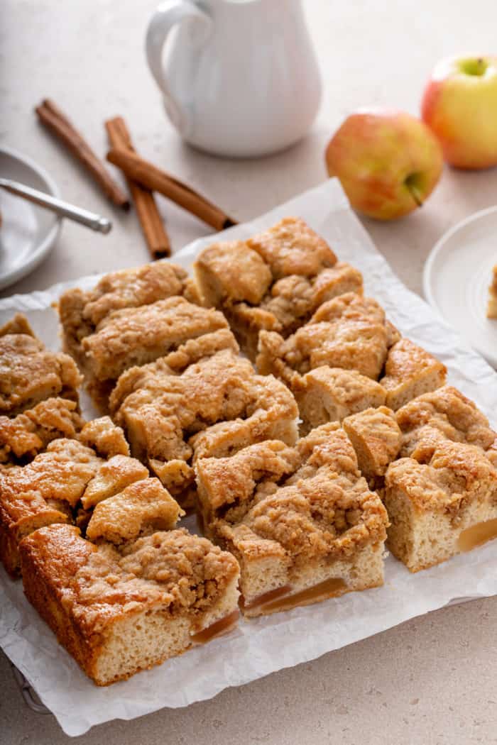 Easy apple coffee cake cut into slices on a piece of parchment paper.