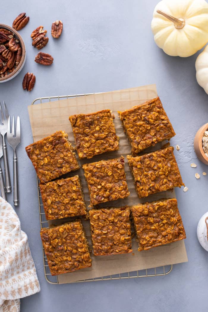 Overhead view of slices of baked oatmeal on a piece of parchment paper.