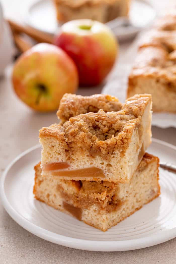 Two stacked slices of easy apple coffee cake on a white plate.