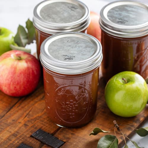 Three jars of canned apple butter.