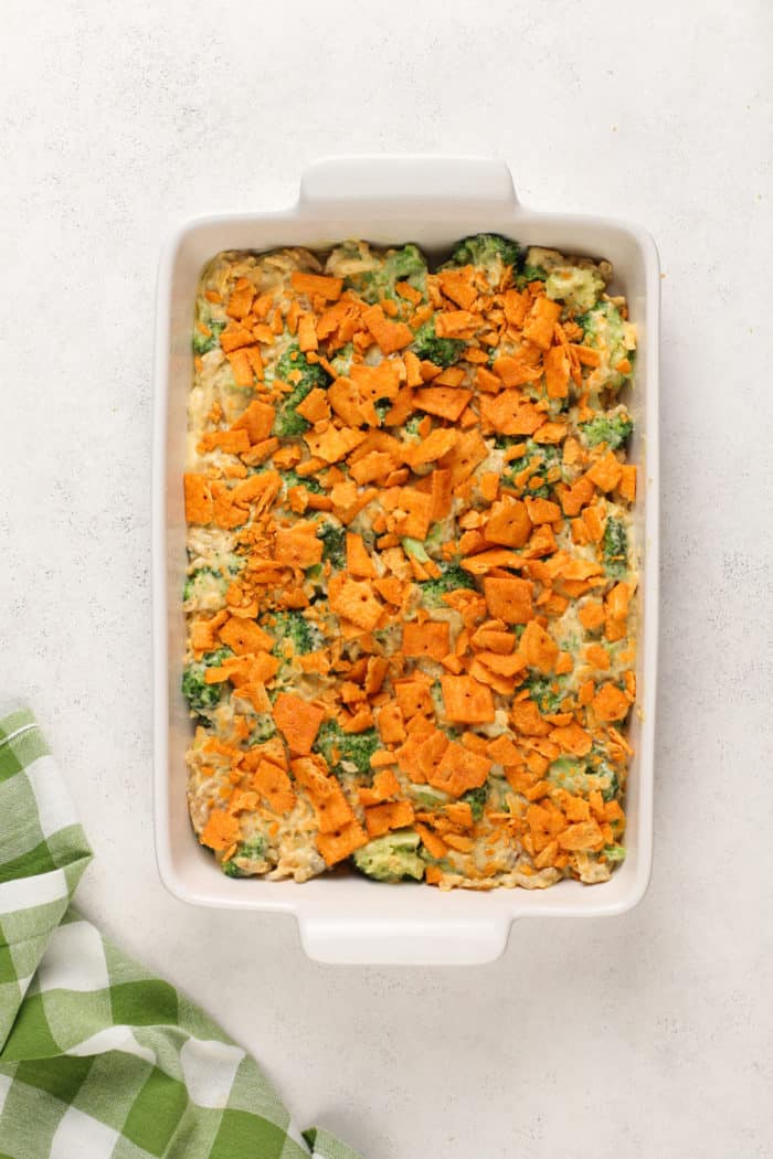 Assembled broccoli casserole in a white baking dish, ready to go in the oven.