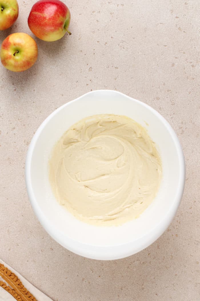 White cake batter in a white mixing bowl.