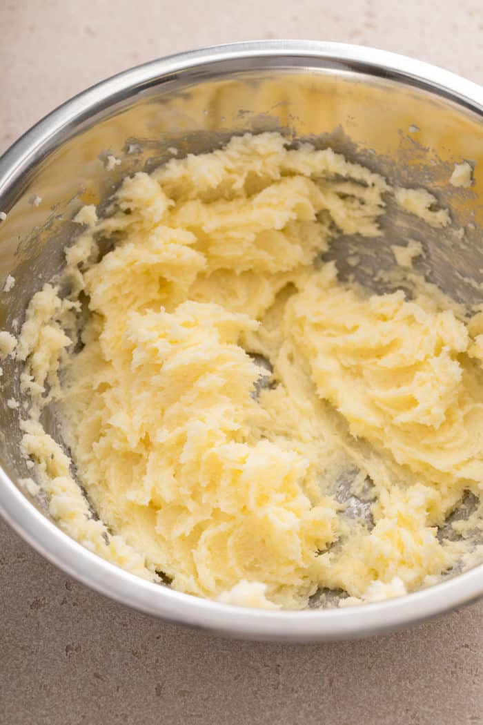 Butter and sugar creamed for 1 minute in a metal bowl.