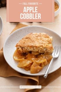 Serving of apple cobbler next to a fork in a shallow bowl. Text overlay includes recipe name.