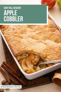 Spoon about to dish out a serving of apple cobbler from a white baking dish. Text overlay includes recipe name.