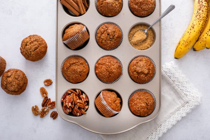 Banana nut muffins arranged in a muffin tin.