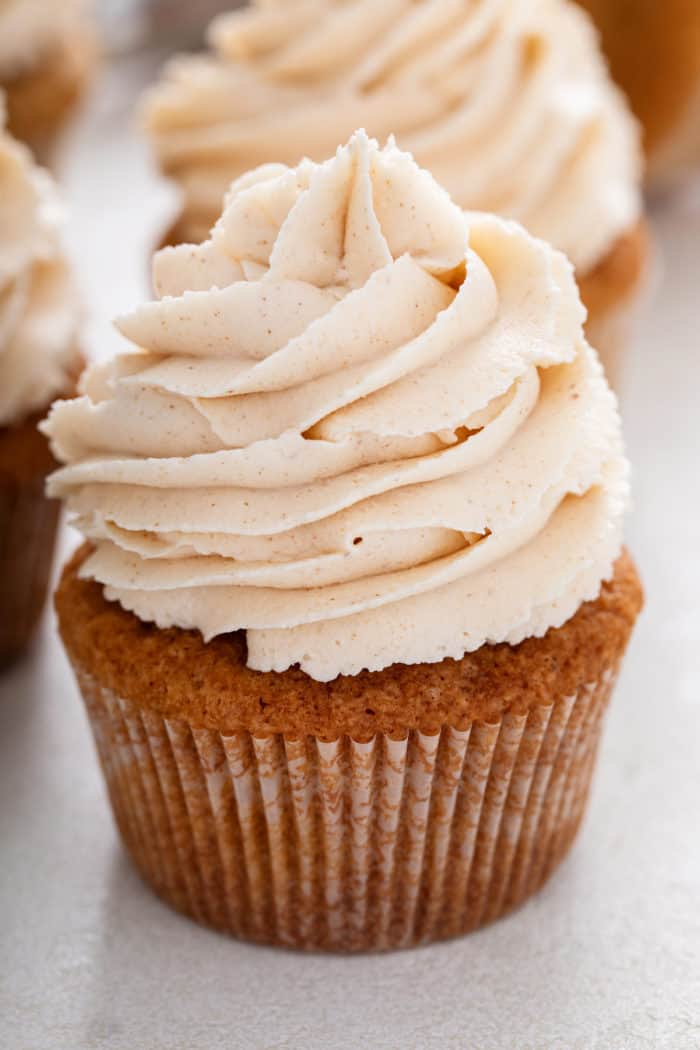 Close up of a spice cupcake topped with brown butter frosting.