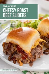 Close up of cheesy roast beef slider on a white plate. Text overlay includes recipe name.