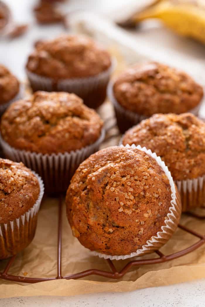 Banana nut muffins arranged on a wire cooling rack.