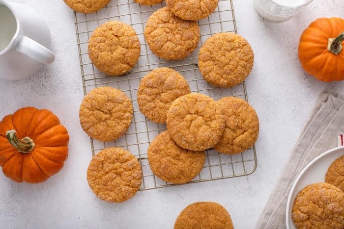 Pumpkin snickerdoodles cooling on a wire rack.