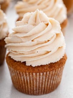 Close up of a spice cupcake topped with brown butter frosting.