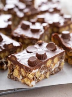 Close up of a peanut butter cup rice krispie treat surrounded by other sliced krispie treats.