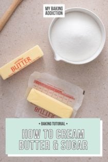 Bowl of sugar, two sticks of butter, and a silicone spatula arranged on a beige countertop. One of the sticks of butter is unwrapped. Text overlay includes tutorial name.