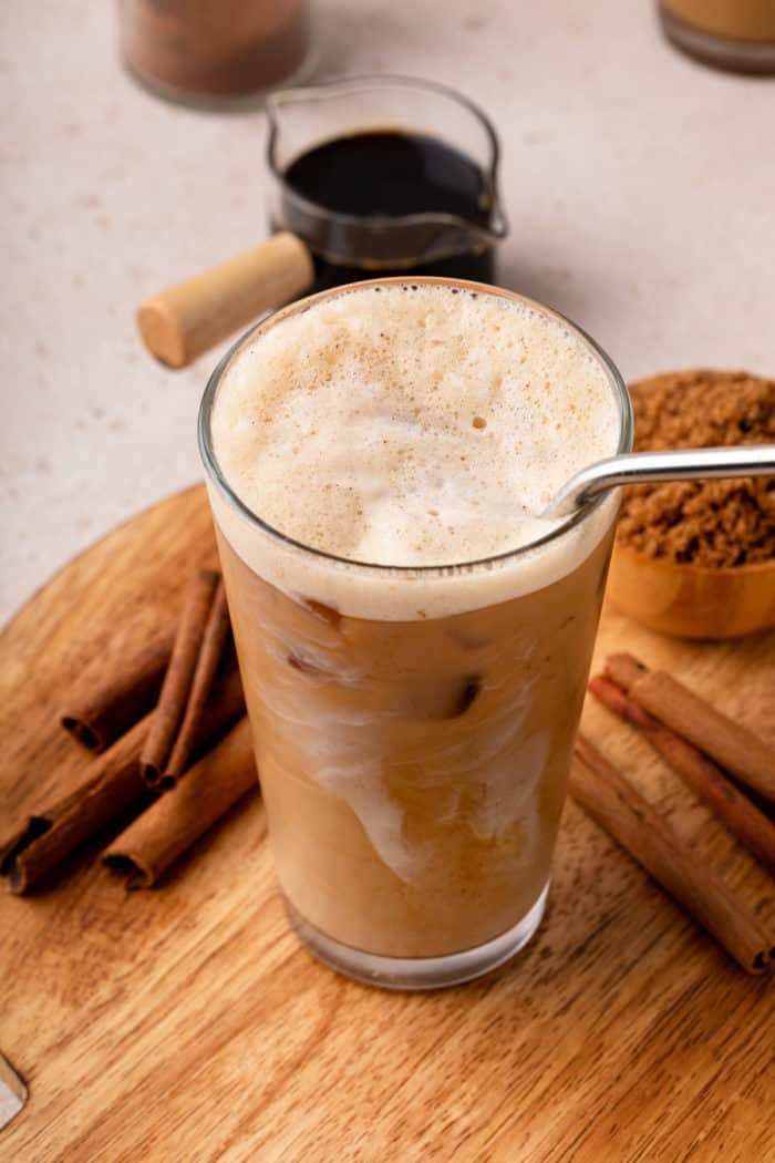 Image of shaken espresso in a tall glass showing the frothy top of the espresso.