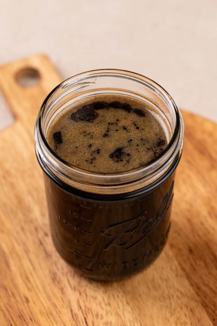 Glass jar filled with brown sugar syrup.