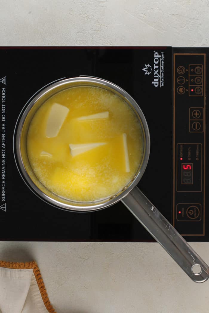 Butter melting in a metal saucepan.