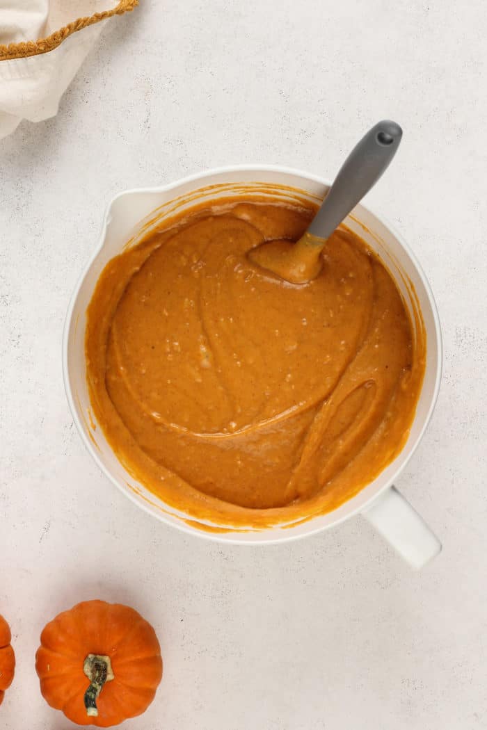 Pumpkin bread batter in a white mixing bowl.
