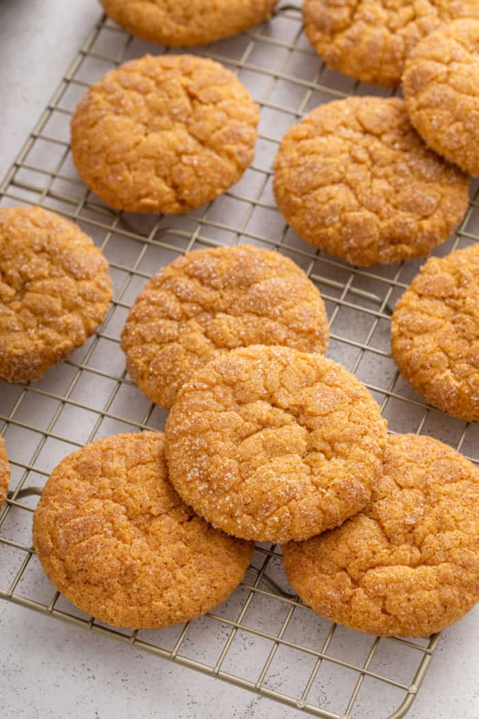 Close up image of pumpkin snickerdoodles on a wire cooling rack.