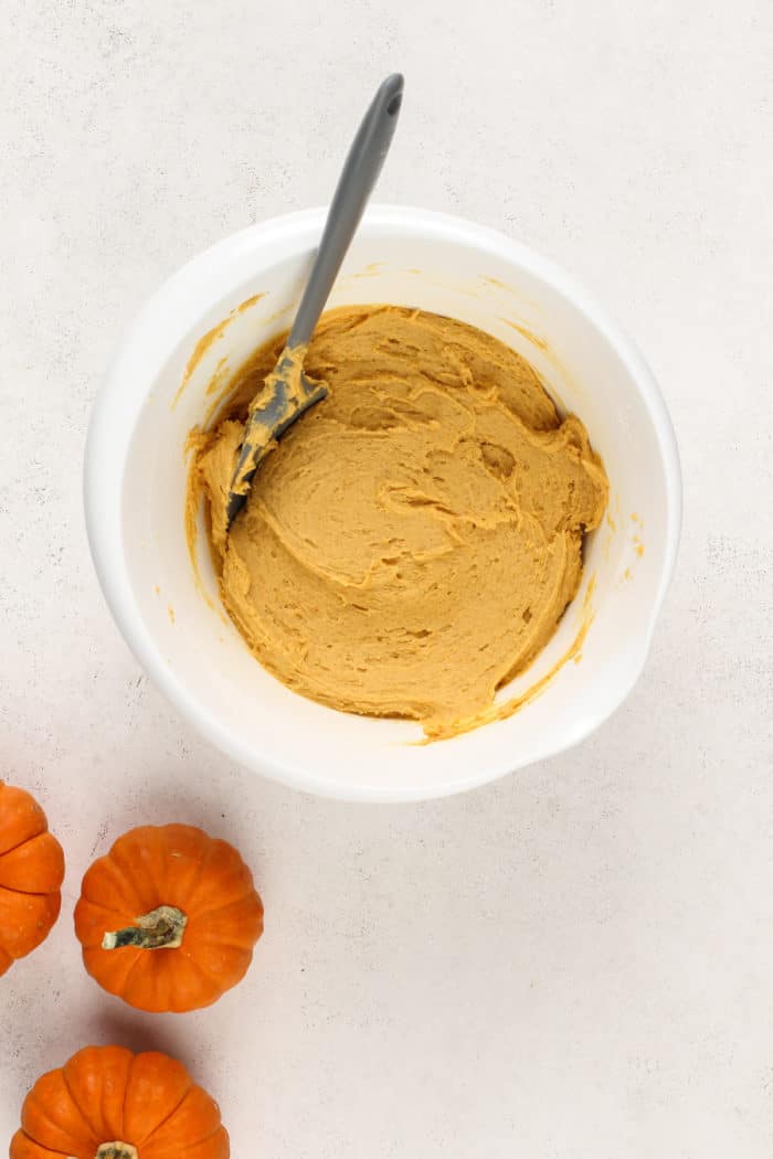 Pumpkin snickerdoodle dough in a white mixing bowl.