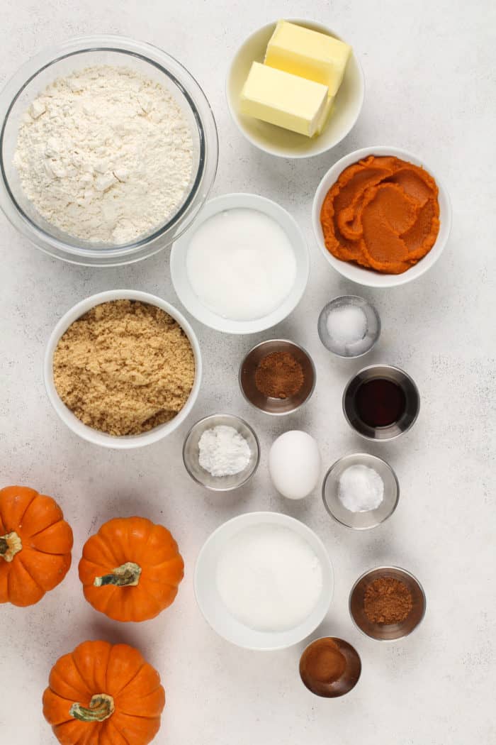 Ingredients for pumpkin snickerdoodles arranged on a white countertop.