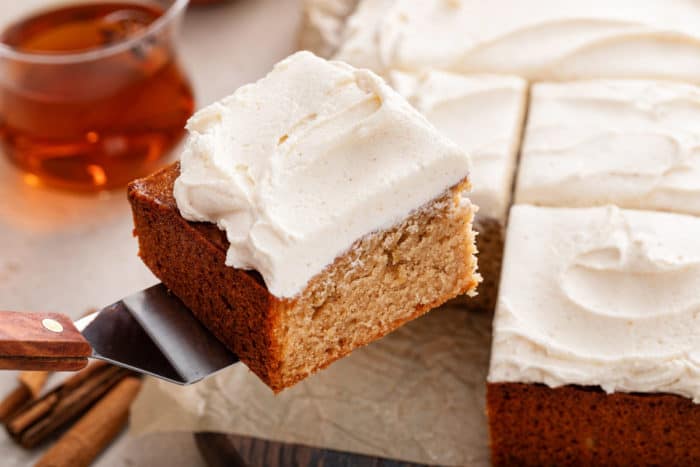 Cake server lifting up a slice of apple butter cake.