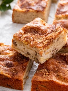 Slice of homemade apple cake set on two other slices.