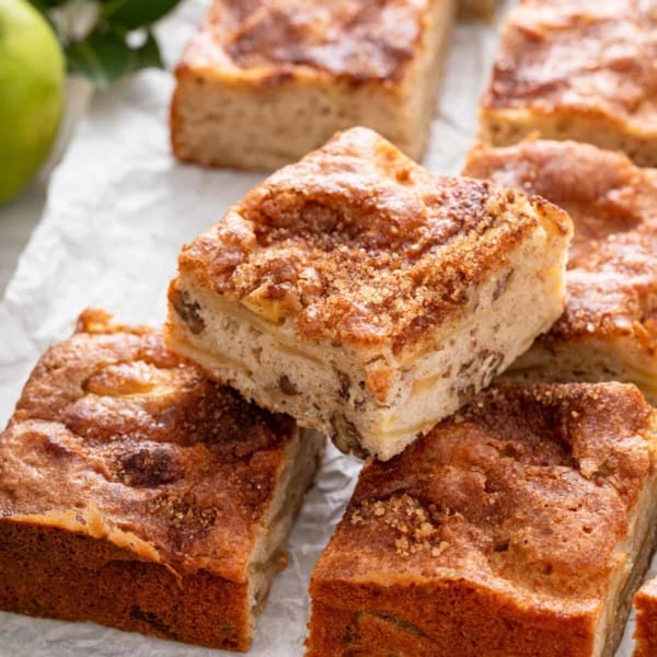 Slice of homemade apple cake set on two other slices.