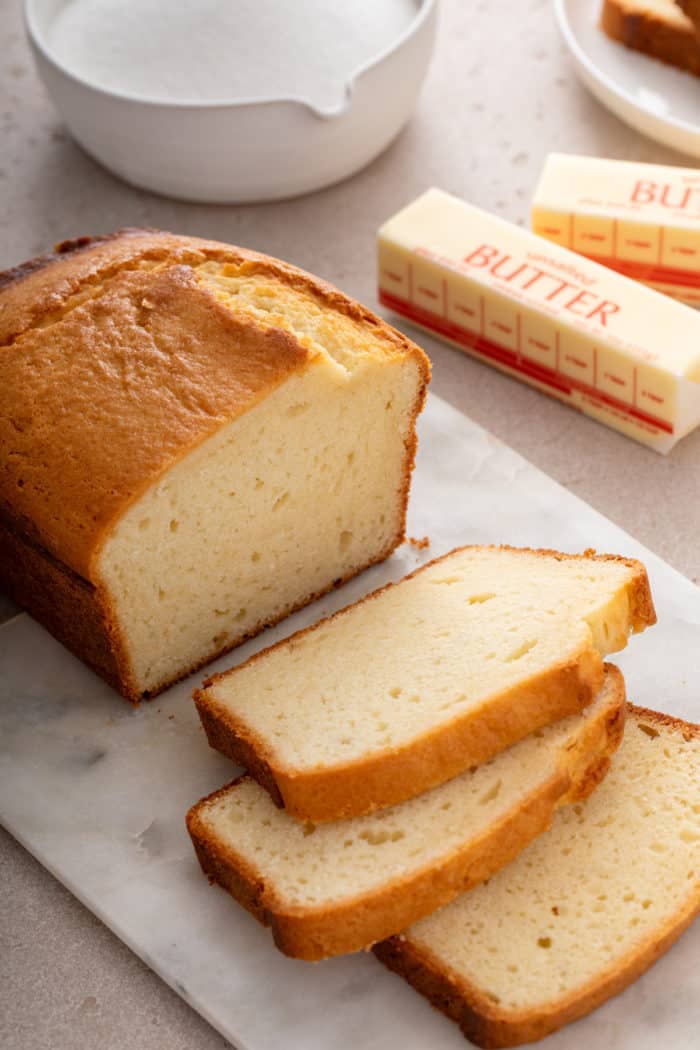 Sliced pound cake on a marble board.