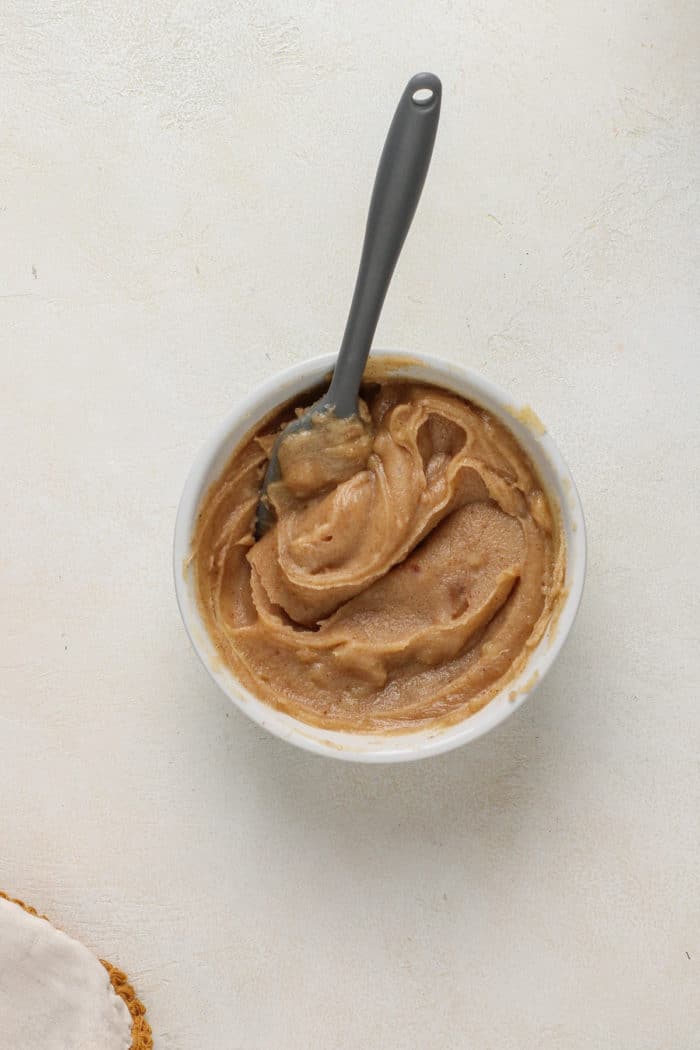 Solidified brown butter in a small white bowl.