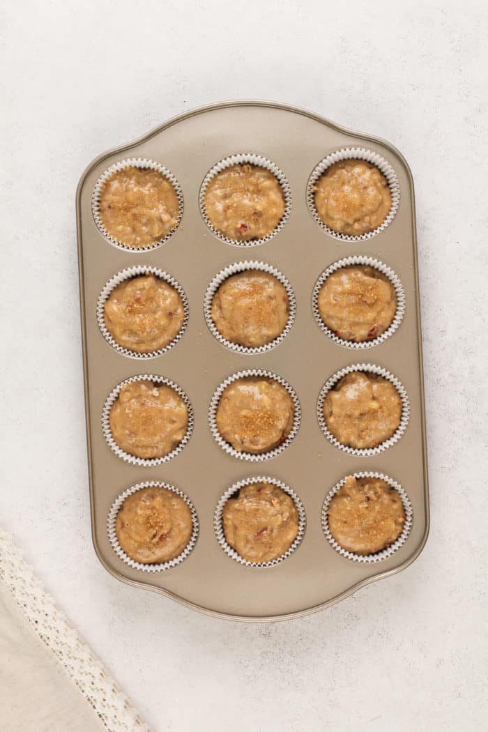 Banana nut muffin batter in a muffin tin, ready to go in the oven.