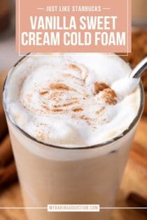 Close up of vanilla sweet cream cold foam dusted with cinnamon on top of a glass of iced coffee. Text overlay includes recipe name.
