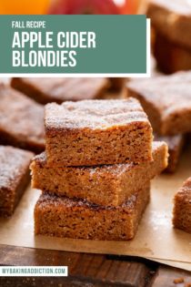 Three apple cider blondies stacked in a piece of brown parchment paper. Text overlay includes recipe name.