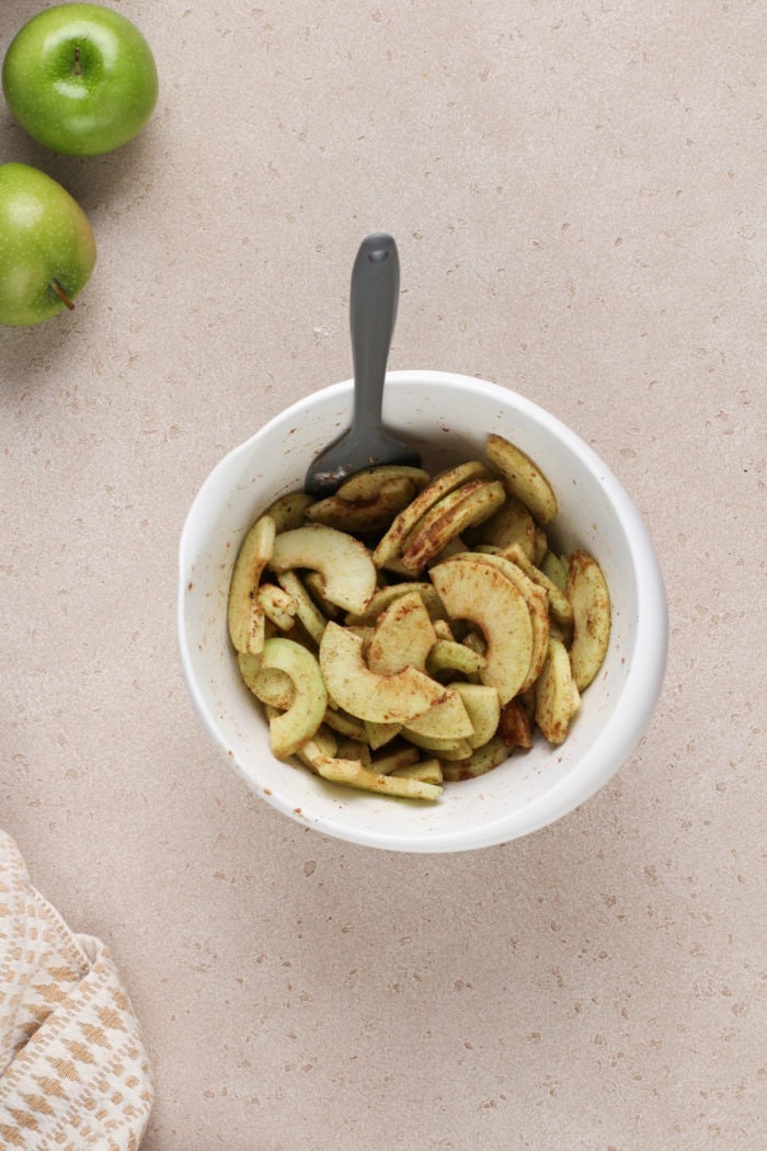 Apple filling for apple crisp bars in a white bowl.