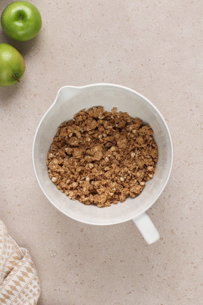 Crisp topping for apple crisp bars in a white mixing bowl.